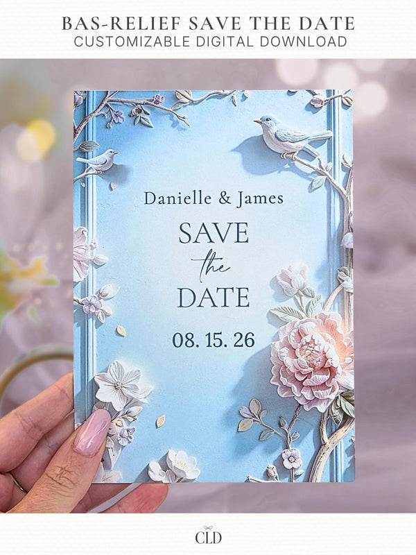Printable Bas-Relief Save the Date shown as a held card featuring a sculpted three-dimensional floral design with peonies, branches, and small birds in a soft blue and blush palette, editable Canva template for an elegant or quiet-luxury wedding.