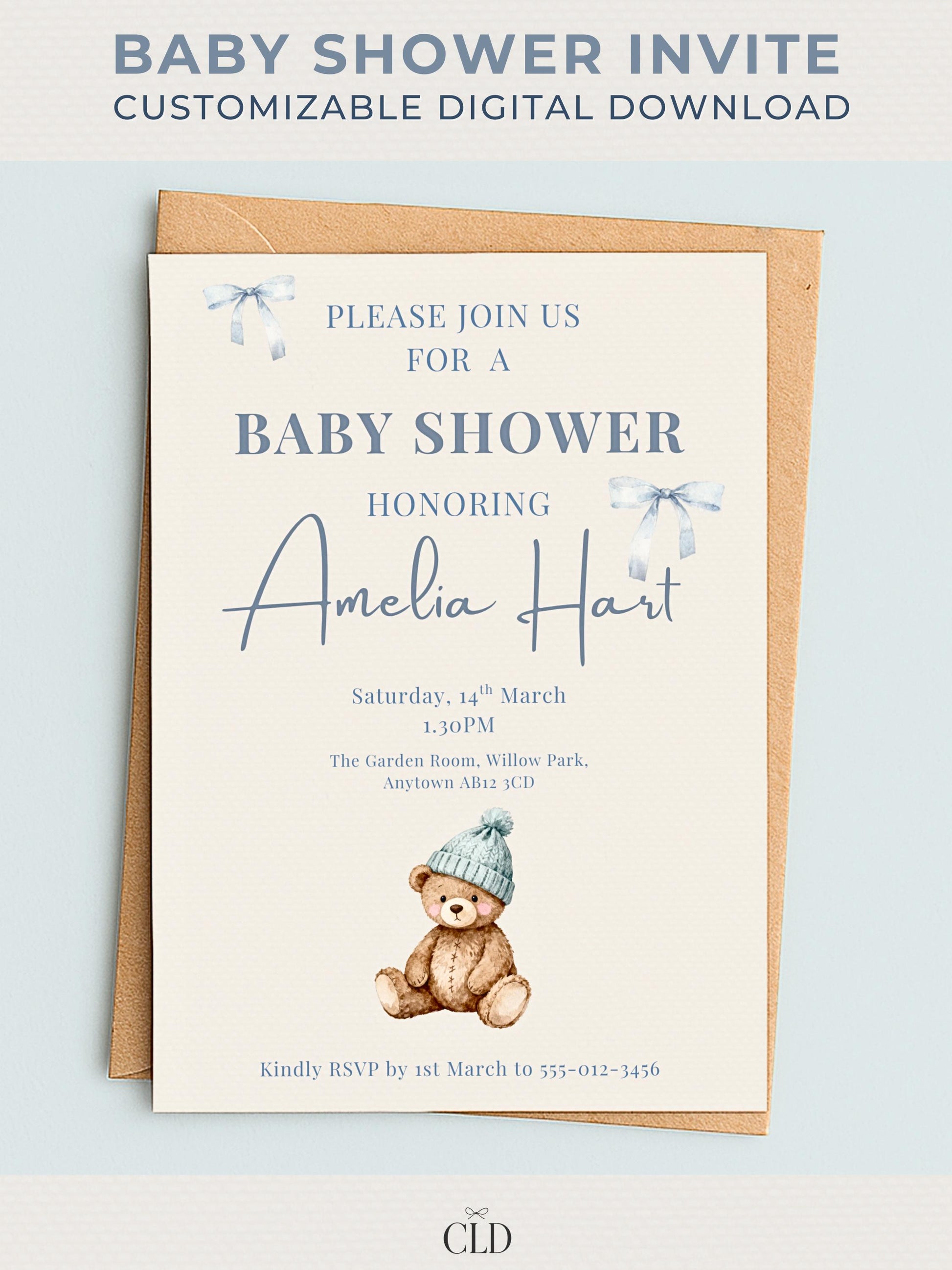 Neutral beige baby shower invitation featuring a watercolor teddy bear in a blue beanie, surrounded by soft blue ribbon bows. Text reads “Please Join Us For A Baby Shower Honoring Amelia Hart.” Elegant modern layout displayed on kraft envelope with Chelsea Lamont Design branding.