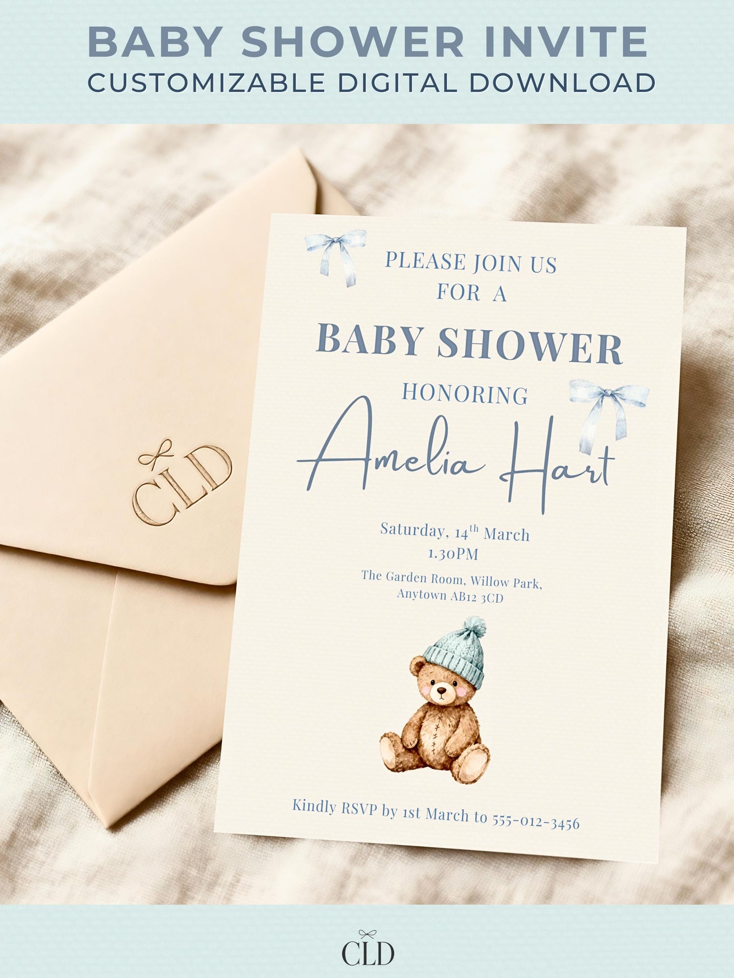 Neutral beige baby shower invitation featuring a watercolor teddy bear in a blue beanie, surrounded by soft blue ribbon bows. Text reads “Please Join Us For A Baby Shower Honoring Amelia Hart.” Elegant modern layout displayed on kraft envelope with Chelsea Lamont Design branding.