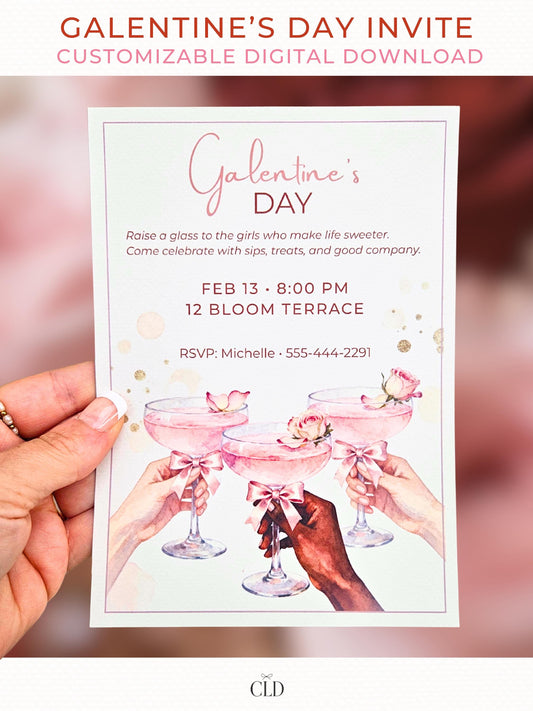 Hand holding a blush pink watercolor Galentine’s Day invitation featuring three women’s hands raising rose cocktails with bows, shown against a soft Valentine-themed bokeh background