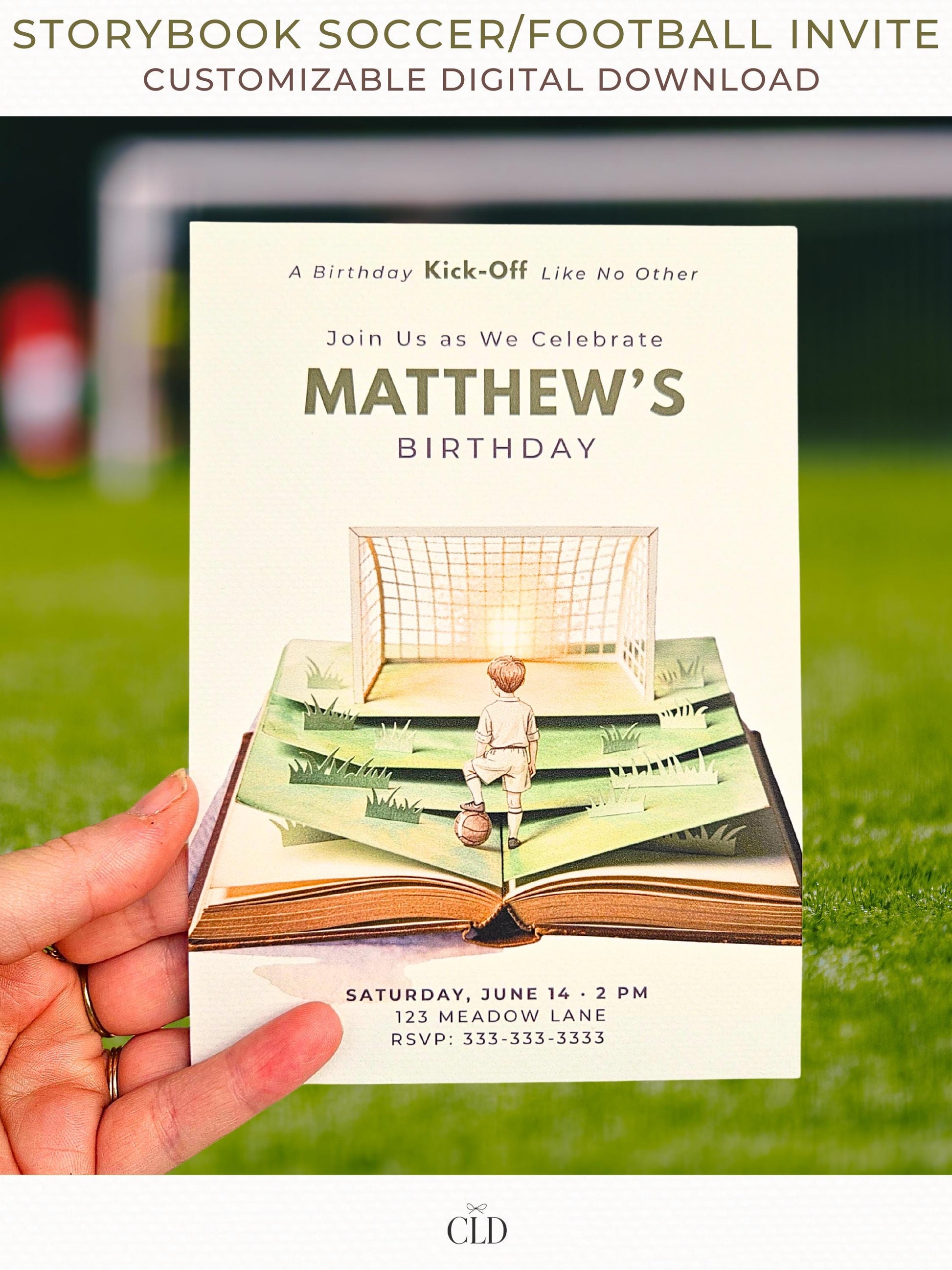 Printable storybook soccer birthday invitation featuring a watercolor pop-up book with a boy standing on layered green pages, a football at his feet, and a glowing goal ahead, held in hand on a soccer field background.