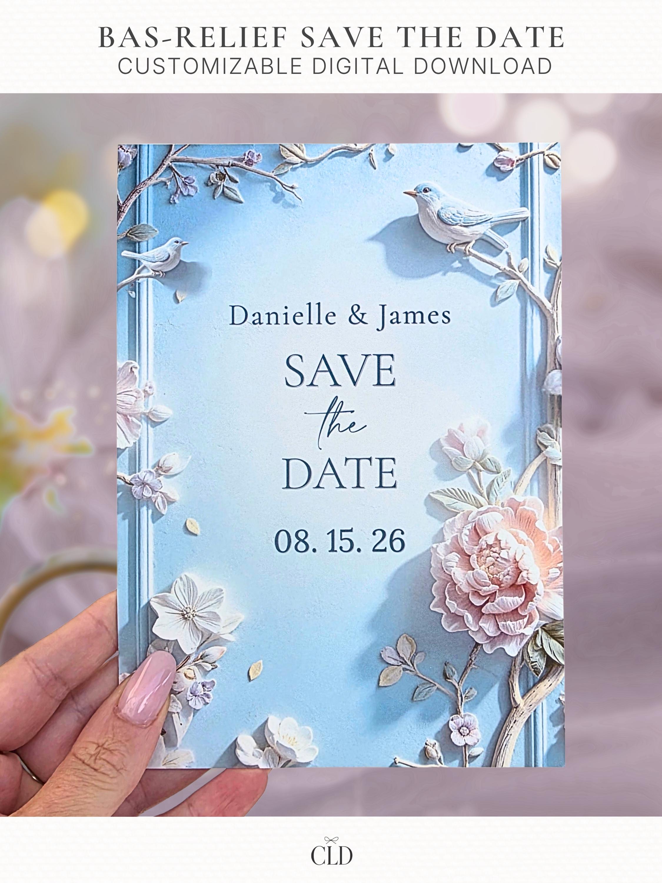 Printable Bas-Relief Save the Date shown as a held card featuring a sculpted three-dimensional floral design with peonies, branches, and small birds in a soft blue and blush palette, editable Canva template for an elegant or quiet-luxury wedding.