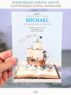 A hand holding a printed pirate birthday invitation showing a watercolor pirate ship sailing out of an open storybook, with paper-style waves, a cannonball, and the birthday details printed above in blue and brown text.
