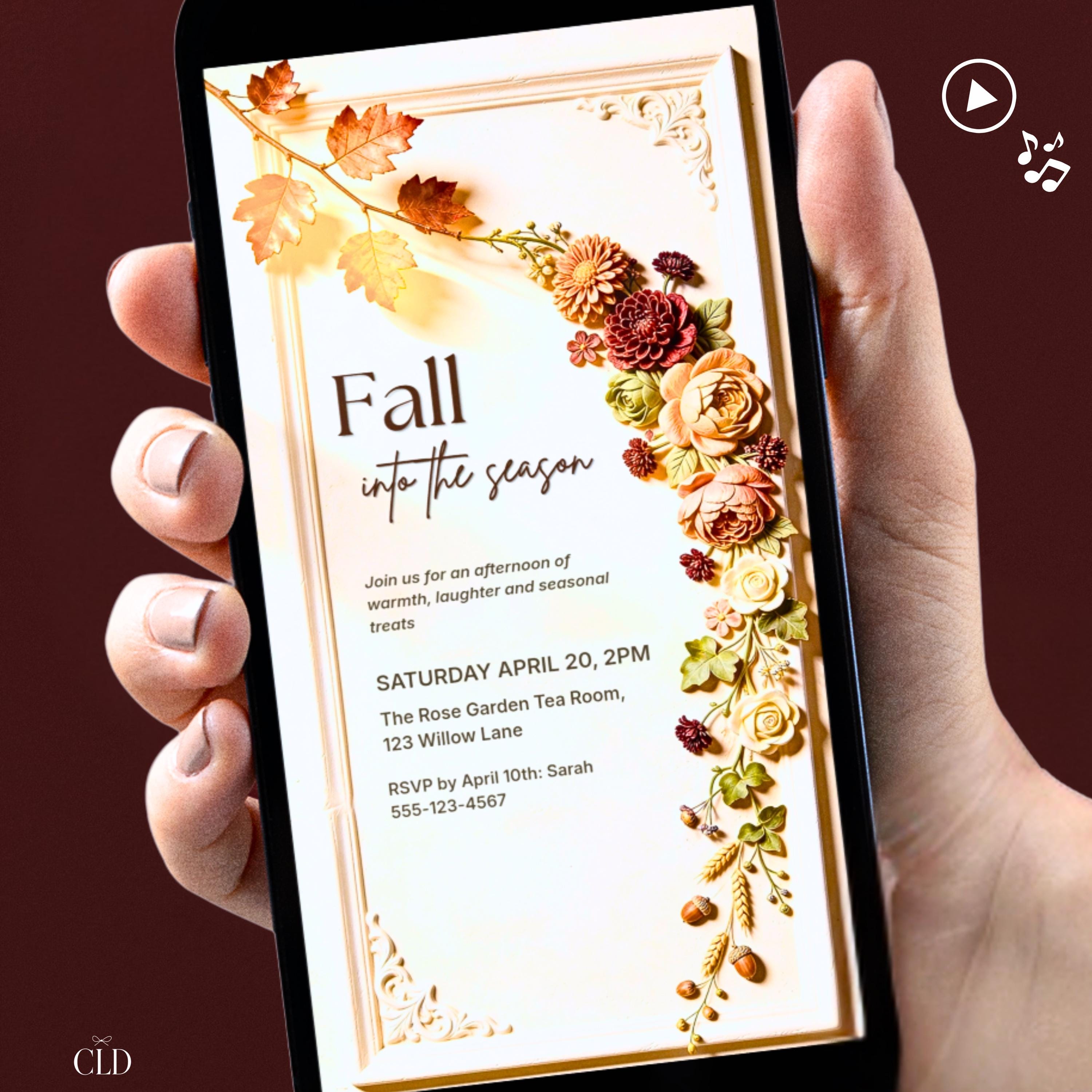 Animated fall invitation on a phone showing a 3D bas relief autumn floral arrangement with peach roses, burgundy dahlias, and gold oak leaves cascading down a cream sculpted frame. Music included. Editable Canva template for Friendsgiving and harvest gatherings.