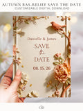 Printable autumn wedding save the date. Sculpted bas-relief florals in blush, peach and terracotta with a terracotta bird and gold leaf accents frame a warm cream centre reading Save the Date, with the names Danielle and James above and the date below. An editable 5x7 Canva template to print at home for a fall wedding.