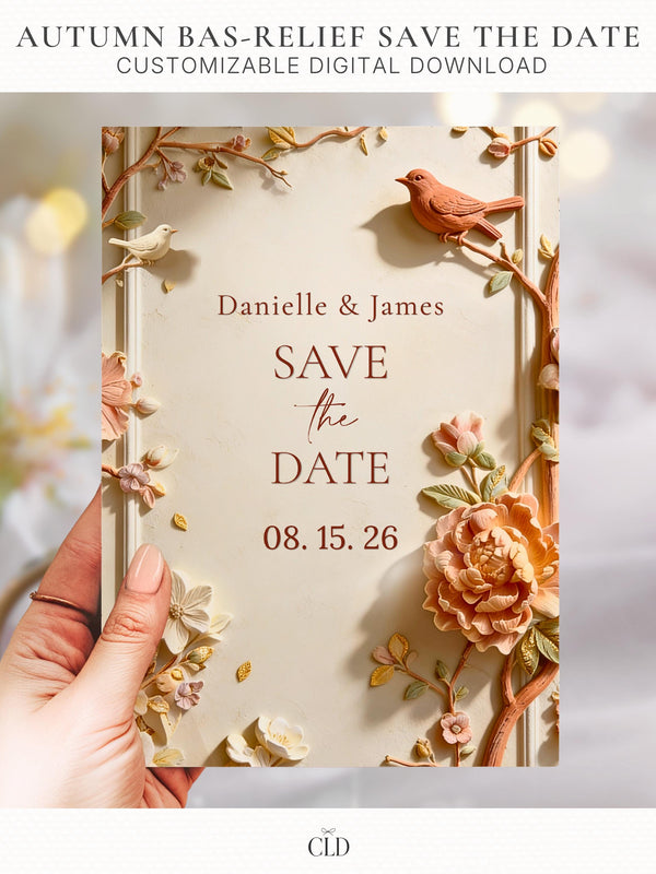 Printable autumn wedding save the date. Sculpted bas-relief florals in blush, peach and terracotta with a terracotta bird and gold leaf accents frame a warm cream centre reading Save the Date, with the names Danielle and James above and the date below. An editable 5x7 Canva template to print at home for a fall wedding.